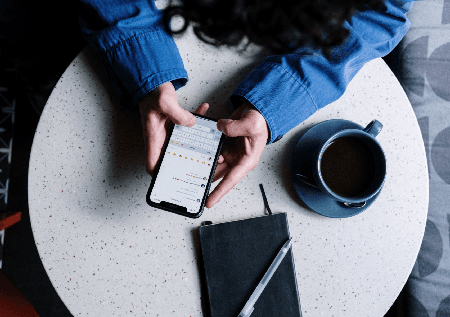 woman holding smartphone over table, illustrating how popular flutter mobile apps are