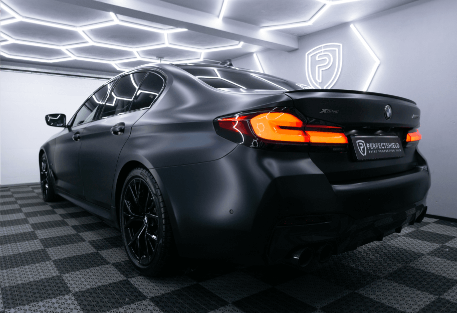 a black sports car in a garage renewed by the Perfectshield team